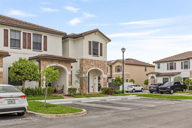3411 W 112th Ter, Hialeah, FL 33018 - townhome / multi-family property featuring uncovered parking, stone siding, and stucco siding