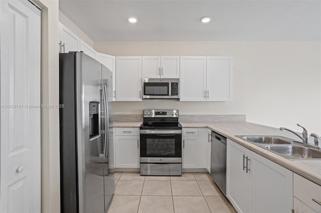 3411 W 112th Ter, Hialeah, FL 33018 - kitchen with stainless steel appliances, white cabinetry, light tile patterned floors, light countertops, and recessed lighting