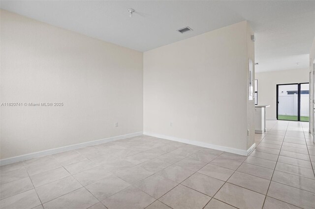 3411 W 112th Ter, Hialeah, FL 33018 - unfurnished room featuring light tile patterned flooring and a pendent fire sprinkler