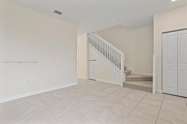 3411 W 112th Ter, Hialeah, FL 33018 - unfurnished room featuring stairs and light tile patterned floors