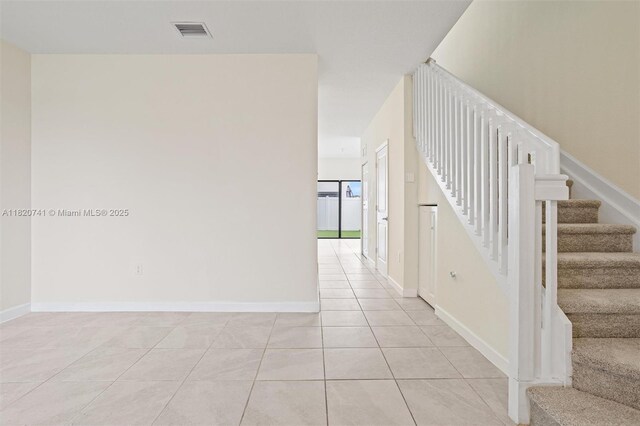 3411 W 112th Ter, Hialeah, FL 33018 - corridor featuring light tile patterned flooring and stairway