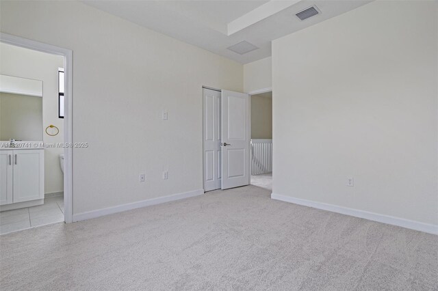 3411 W 112th Ter, Hialeah, FL 33018 - unfurnished bedroom with light colored carpet and ensuite bathroom