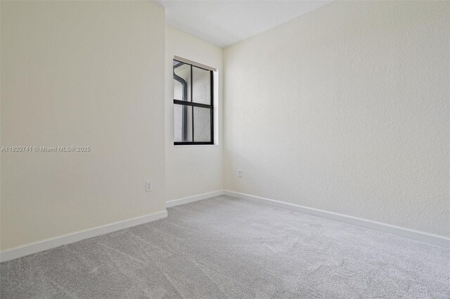 3411 W 112th Ter, Hialeah, FL 33018 - carpeted empty room with baseboards