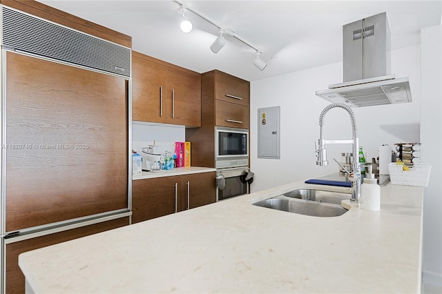 495 Brickell Ave Unit 905, Miami, FL 33131 - kitchen with stainless steel oven, light countertops, island range hood, built in microwave, and rail lighting