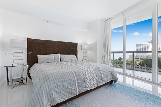 495 Brickell Ave Unit 905, Miami, FL 33131 - bedroom with a wall of windows, tile patterned flooring, and access to exterior