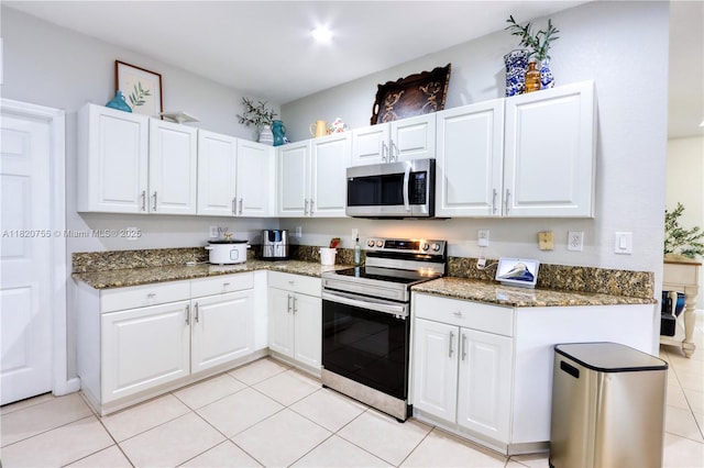 148 NE 36th Avenue Rd, Homestead, FL 33033 - kitchen featuring stainless steel appliances, white cabinetry, and dark stone countertops
