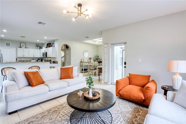 148 NE 36th Avenue Rd, Homestead, FL 33033 - living room with a chandelier, arched walkways, light tile patterned flooring, and recessed lighting