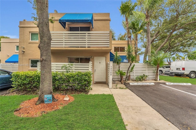 14388 SW 96th Ln, Miami, FL 33186 - townhome / multi-family property with a balcony, stucco siding, and uncovered parking