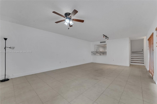 14388 SW 96th Ln, Miami, FL 33186 - unfurnished living room featuring stairway, a ceiling fan, track lighting, and a textured ceiling