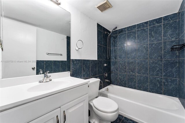 14388 SW 96th Ln, Miami, FL 33186 - bathroom featuring tile walls, shower / washtub combination, and vanity