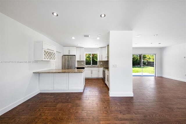 9221 SW 167th Ter, Palmetto Bay, FL 33157 - kitchen featuring appliances with stainless steel finishes, a peninsula, open floor plan, dark wood-style floors, and white cabinetry