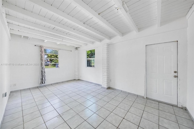 9221 SW 167th Ter, Palmetto Bay, FL 33157 - empty room featuring light tile patterned floors and a wood ceiling with exposed beams