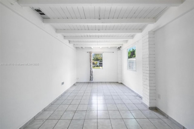 9221 SW 167th Ter, Palmetto Bay, FL 33157 - spare room with beamed ceiling and light tile patterned floors