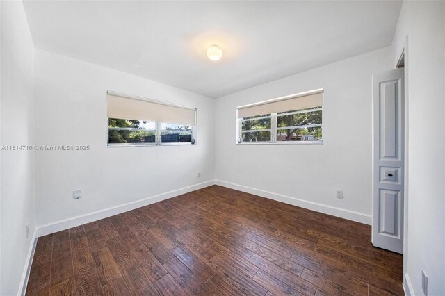 9221 SW 167th Ter, Palmetto Bay, FL 33157 - empty room featuring dark wood finished floors and baseboards