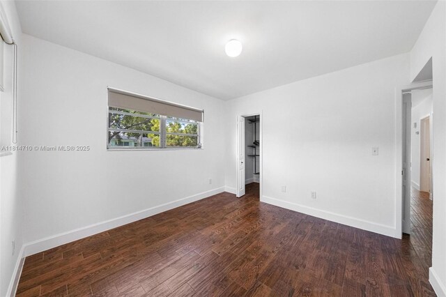 9221 SW 167th Ter, Palmetto Bay, FL 33157 - unfurnished bedroom with wood finished floors and baseboards