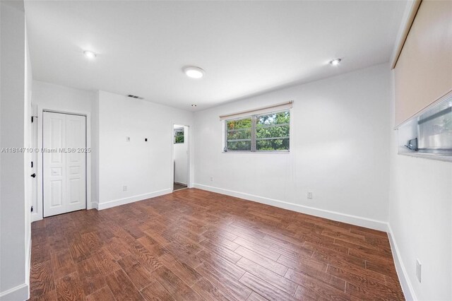 9221 SW 167th Ter, Palmetto Bay, FL 33157 - unfurnished bedroom with wood finished floors and baseboards