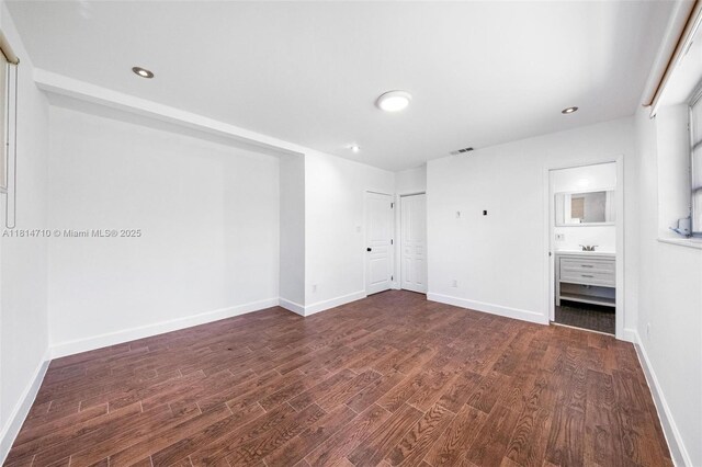9221 SW 167th Ter, Palmetto Bay, FL 33157 - unfurnished bedroom with dark wood-style floors, recessed lighting, and ensuite bathroom