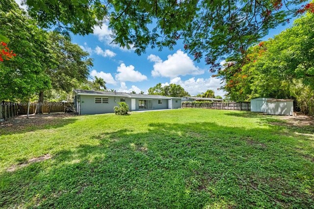 9221 SW 167th Ter, Palmetto Bay, FL 33157 - fenced backyard featuring a storage unit