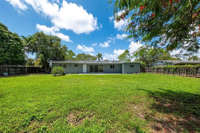 9221 SW 167th Ter, Palmetto Bay, FL 33157 - rear view of house with a fenced backyard and stucco siding