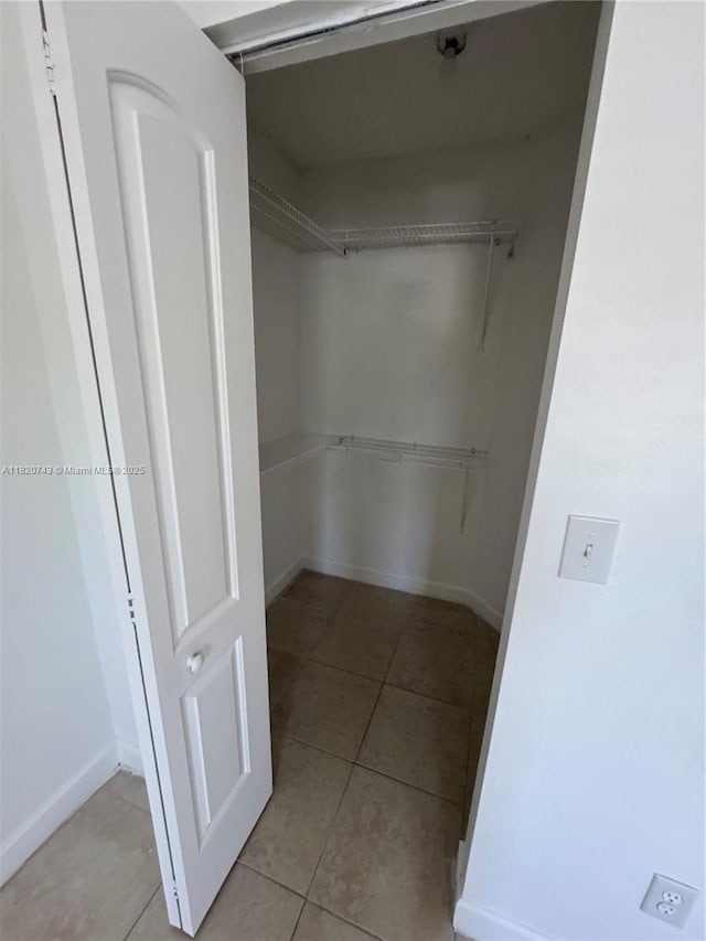 18346 NW 68th Ave Unit K, Hialeah, FL 33015 - walk in closet featuring tile patterned flooring