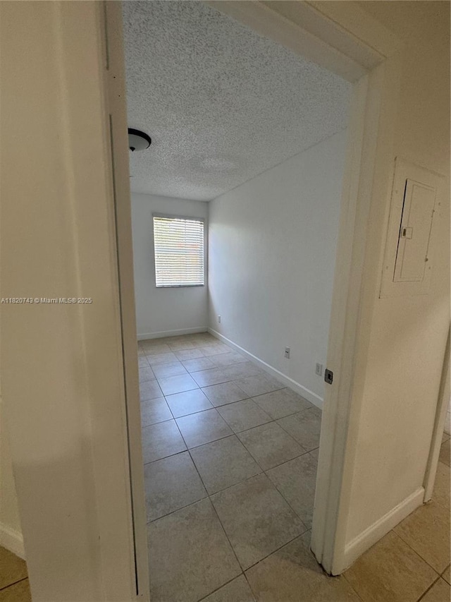 18346 NW 68th Ave Unit K, Hialeah, FL 33015 - unfurnished room with tile patterned flooring, electric panel, and a textured ceiling
