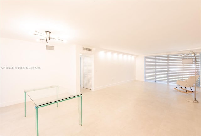 1750 NE 191st St Unit 100-1, Miami, FL 33179 - spare room with baseboards and a chandelier