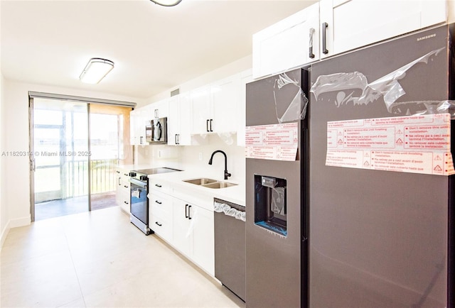 1750 NE 191st St Unit 100-1, Miami, FL 33179 - kitchen with appliances with stainless steel finishes, white cabinetry, and light countertops