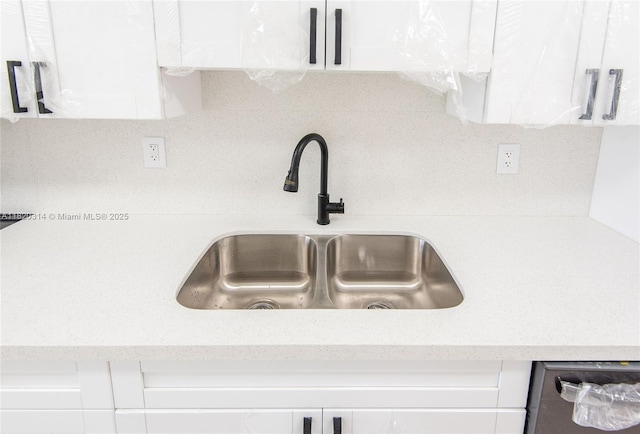 1750 NE 191st St Unit 100-1, Miami, FL 33179 - kitchen view of white cabinetry, tasteful backsplash, and stainless steel dishwasher