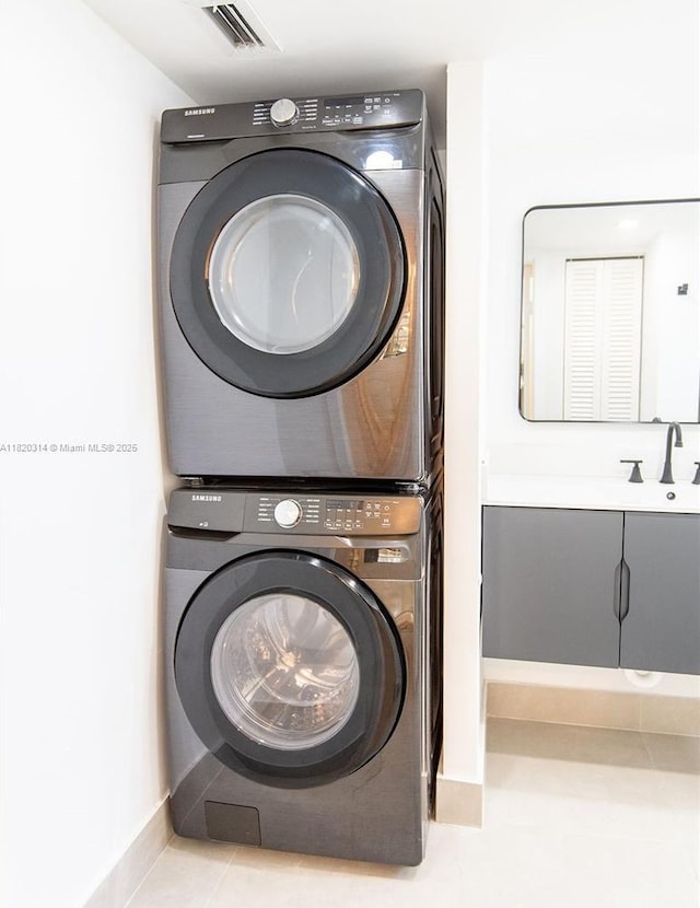 1750 NE 191st St Unit 100-1, Miami, FL 33179 - washroom featuring estacked washer and dryer and baseboards