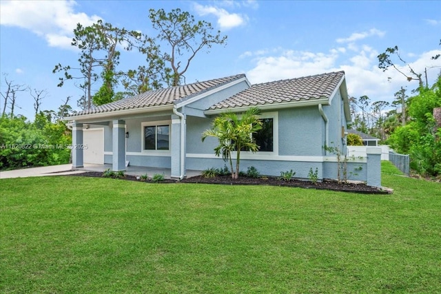 18125 Wintergarden Ave, Port Charlotte, FL 33948 - view of front of home featuring a front lawn, a tiled roof, stucco siding, and an attached garage