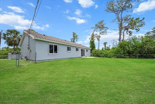 18125 Wintergarden Ave, Port Charlotte, FL 33948 - rear view of property featuring stucco siding and a tile roof