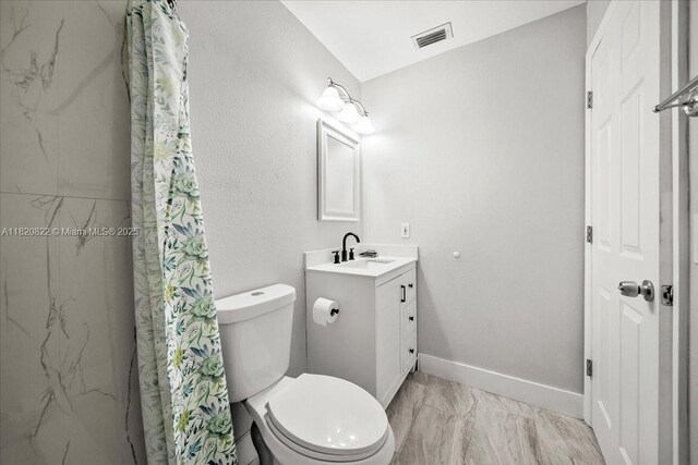 18125 Wintergarden Ave, Port Charlotte, FL 33948 - full bathroom featuring vanity, curtained shower, and marble finish flooring