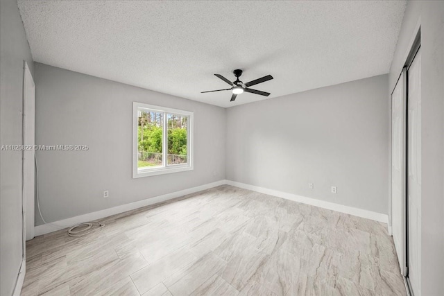 18125 Wintergarden Ave, Port Charlotte, FL 33948 - unfurnished bedroom with a textured ceiling, a closet, and a ceiling fan