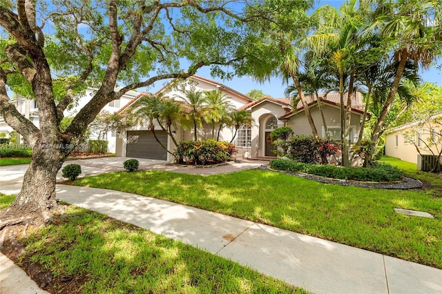 1971 Landing Way, Weston, FL 33326 - mediterranean / spanish-style house featuring concrete driveway, stucco siding, a front lawn, an attached garage, and a tile roof