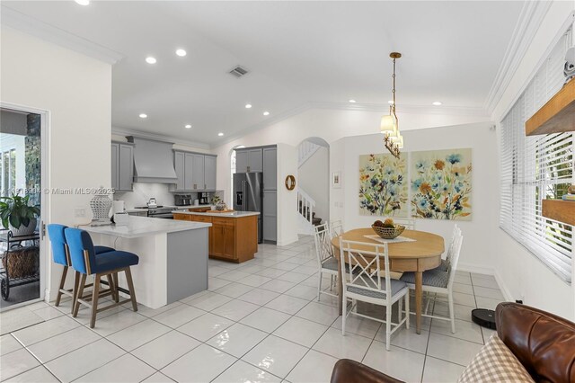 1971 Landing Way, Weston, FL 33326 - kitchen with premium range hood, gray cabinets, appliances with stainless steel finishes, ornamental molding, and light countertops