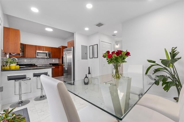 18062 NW 74th Ct, Hialeah, FL 33015 - dining space featuring light marble finish flooring, recessed lighting, and electric panel