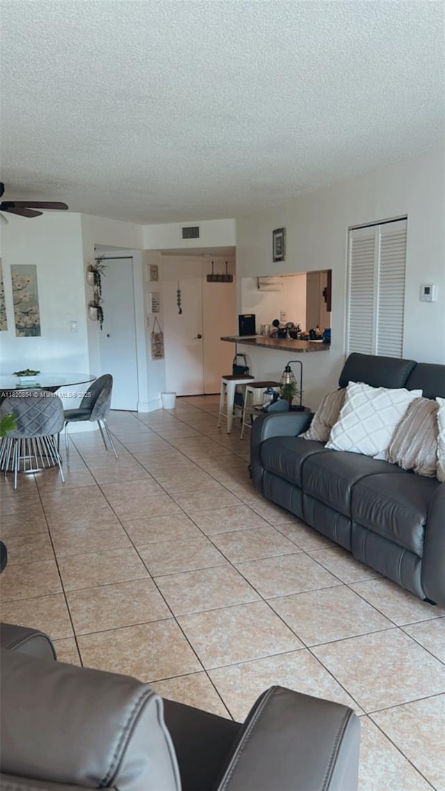 953 Coral Club Dr Unit 953, Coral Springs, FL 33071 - living area with a textured ceiling, light tile patterned floors, and ceiling fan