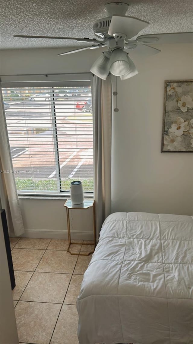 953 Coral Club Dr Unit 953, Coral Springs, FL 33071 - bedroom with light tile patterned floors, ceiling fan, and a textured ceiling