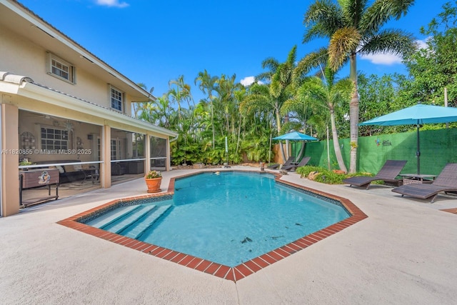 12821 SW 148th St Rd, Miami, FL 33186 - view of swimming pool with a sunroom and a patio area