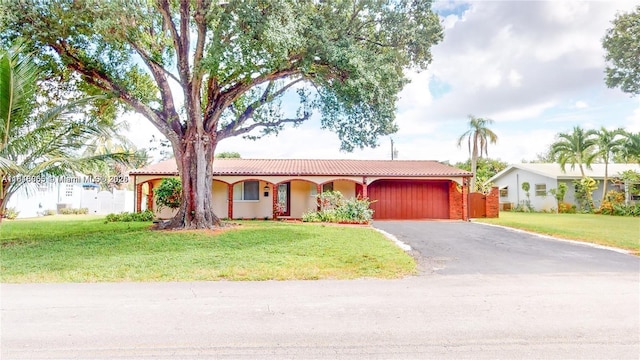 2116 NW 3rd Ave, Wilton Manors, FL 33311 - view of front of property with driveway, a garage, a tiled roof, and stucco siding