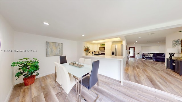 2116 NW 3rd Ave, Wilton Manors, FL 33311 - dining space featuring light wood-style floors and recessed lighting