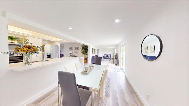2116 NW 3rd Ave, Wilton Manors, FL 33311 - dining room featuring light wood-style floors and recessed lighting