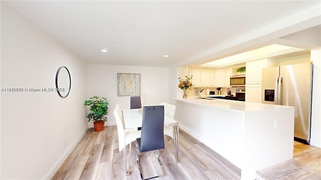 2116 NW 3rd Ave, Wilton Manors, FL 33311 - dining area featuring light wood-style floors and recessed lighting