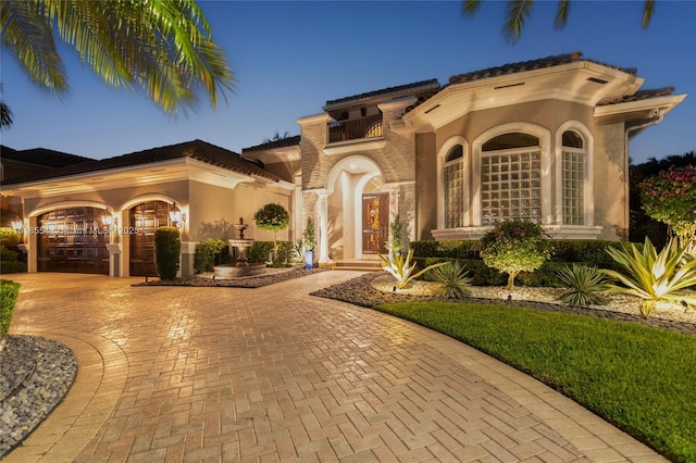 10985 Canary Island Ct, Plantation, FL 33324 - mediterranean / spanish house with curved driveway, stucco siding, and a balcony