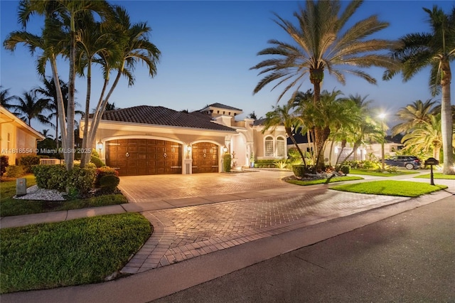 10985 Canary Island Ct, Plantation, FL 33324 - mediterranean / spanish-style home with decorative driveway, an attached garage, stucco siding, and a tiled roof