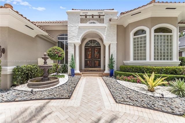 10985 Canary Island Ct, Plantation, FL 33324 - entrance to property featuring french doors, a balcony, stucco siding, and a tiled roof