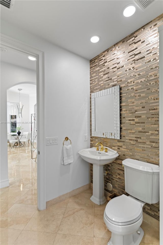 10985 Canary Island Ct, Plantation, FL 33324 - half bath with tile walls, recessed lighting, and a chandelier