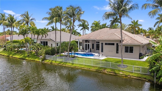10985 Canary Island Ct, Plantation, FL 33324 - rear view of property with stucco siding, a water view, a fenced backyard, a tile roof, and a patio area