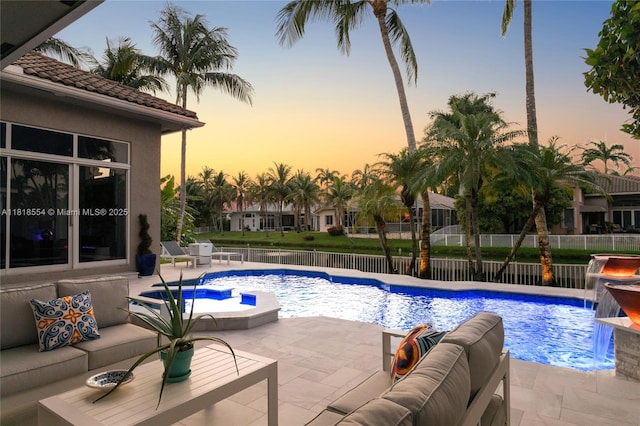 10985 Canary Island Ct, Plantation, FL 33324 - pool at dusk with a patio, outdoor lounge area, a fenced backyard, and a pool with connected hot tub