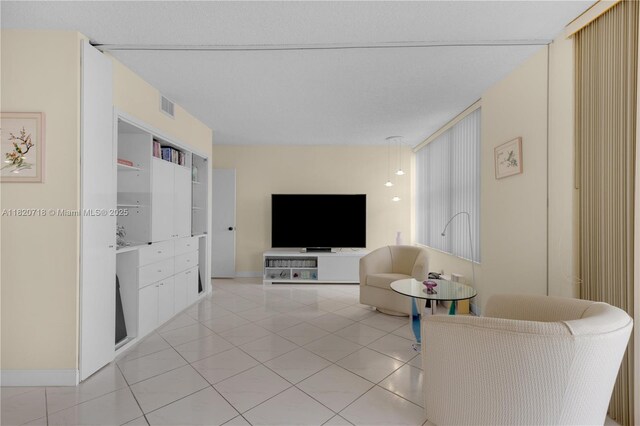 2500 Parkview Dr Unit 1717, Hallandale Beach, FL 33009 - living room featuring light tile patterned flooring and baseboards
